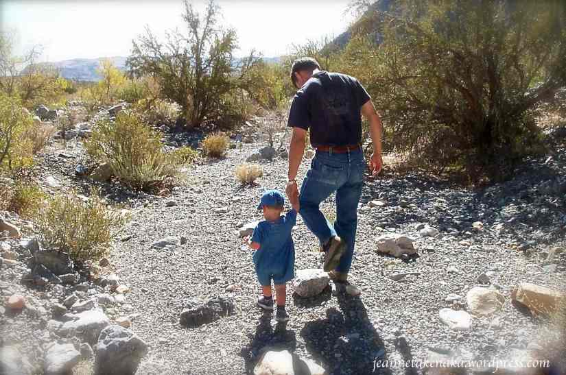 A man walking with a young toddler